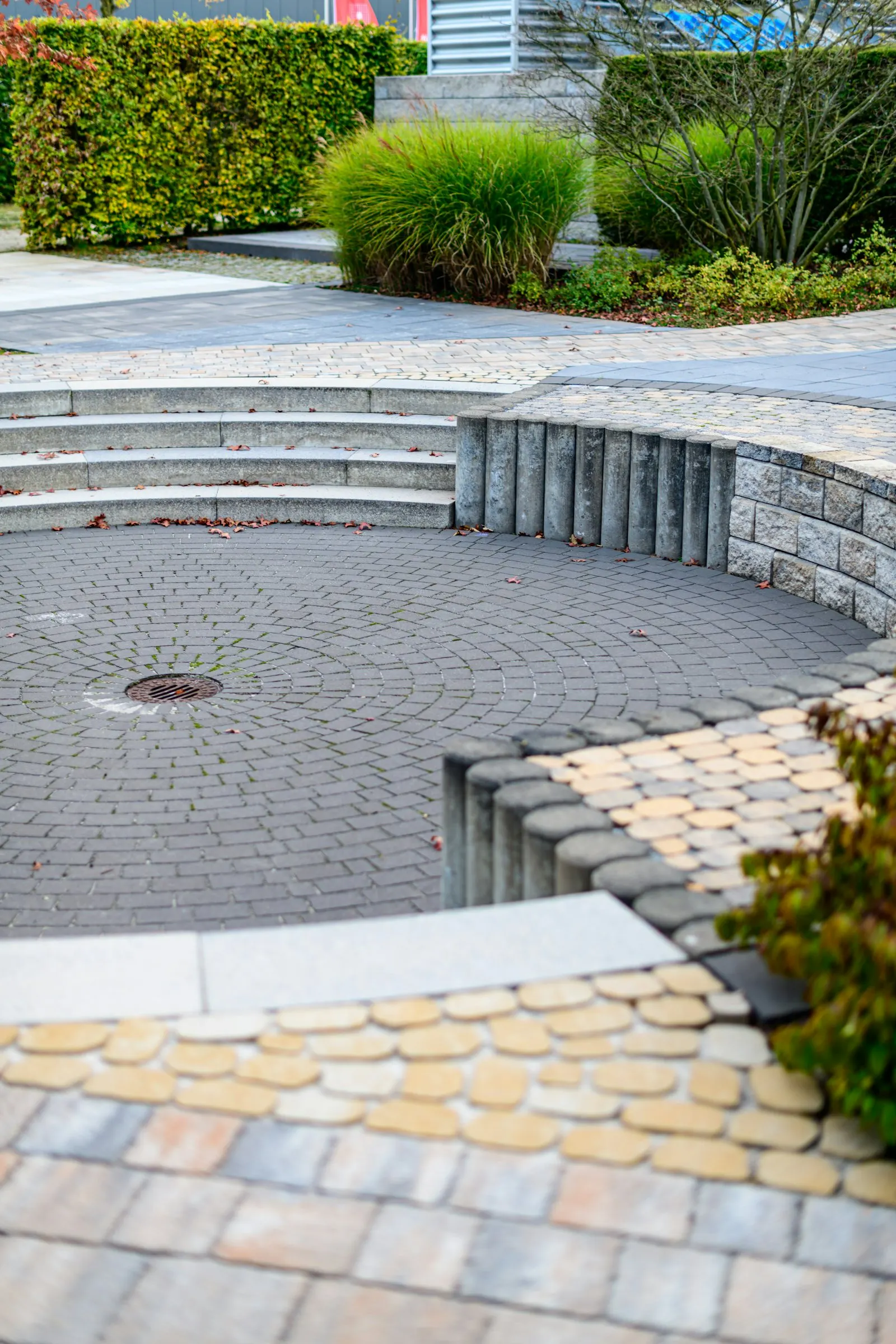 Curved paver seating area set into a desert-friendly planting bed.
